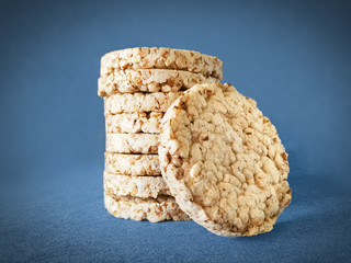 Stack of puffed rice cakes on a blue background
