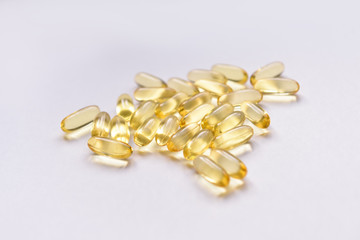 Fish oil capsules with omega 3 and vitamin D on a white background, isolated, healthy nutrition...