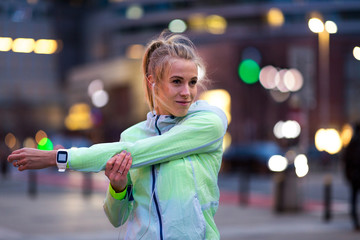 Female runner stretching before jog