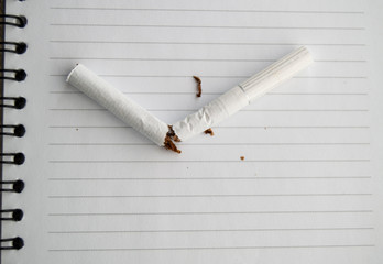 World no tobacco day, no Smoking day. Broken cigarette on business notebook, place for your text