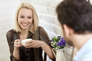 Beautiful young woman drinking coffee