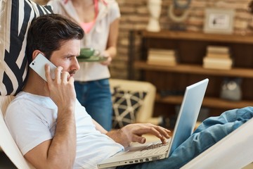 Man with laptop and mobile