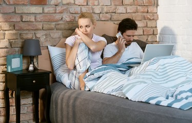 Disappointed young woman in bed