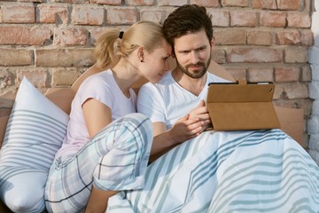 Loving couple with tablet