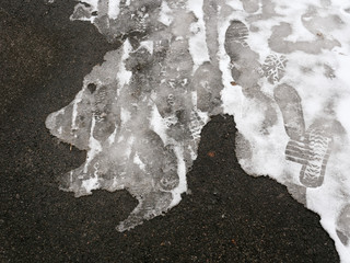on the asphalt of the walkway ice and snow.