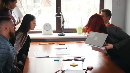 Business concept. A conference. People sits by table and greeting each other with a handshake