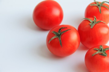 five fresh red tomatoes on white background
