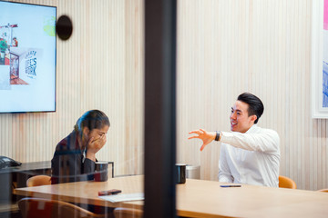 A couple of professional talking about a story during their break. They are really looking good in their attire while enjoying their coffee.