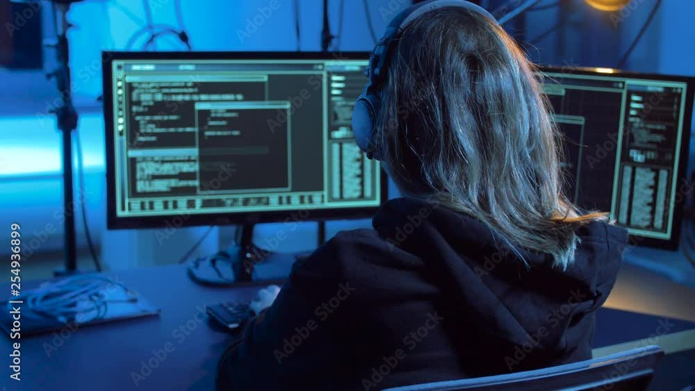 Poster cybercrime, hacking and technology concept - female hacker in dark room creating code or using compu