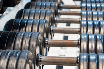 Fototapeta na wymiar Close up image of chrome dumbbells in gym