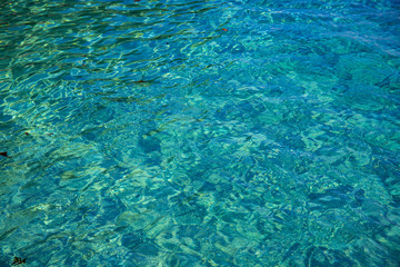 Fototapeta na wymiar Turquoise blue tropic sea water texture. Seawater closeup photo. Idyllic sea surface. Transparent water tropical seaside