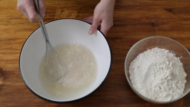 Prepare the dough for homemade baking, hand mixing dry yeast with water