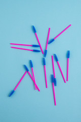 Disposable pink brushes for eyelashes and eyebrows. Close-up.