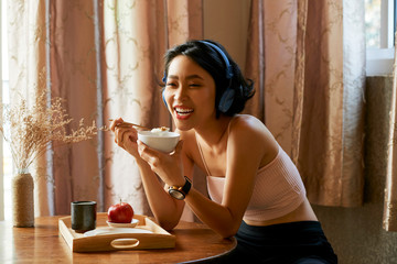Happy woman eating breakfast