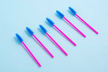 Disposable pink brushes for eyelashes and eyebrows. Close-up.