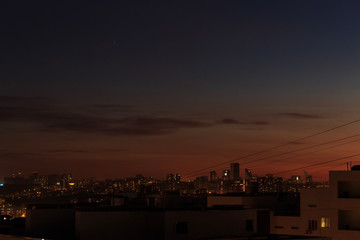 City downtown Sunset.City skyline in the dusk. Amazing panoramic view of modern city.Construction site with cranes on new residential areas