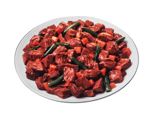 dog food with meat and vegetables in a white plate isolated