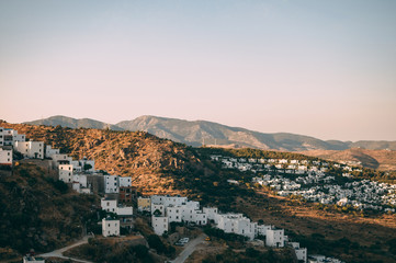 Obraz premium Typical white, cubic Bodrum houses in Turkey with a sea view, during sunset, summer