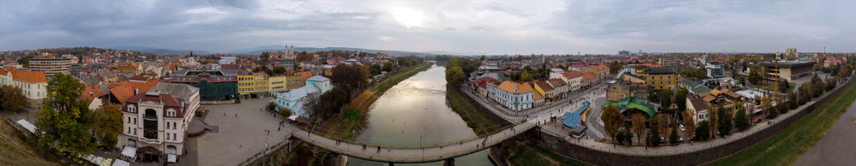 Fototapeta na wymiar View of the river Uzh in the old bridge and cloudy sky autumn Uzhgorod, Transcarpathia, Ukraine