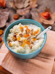Oatmeal with nuts and dried fruits. Autumn background