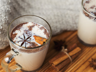 spicy masala tea with cinnamon and anise on wooden background
