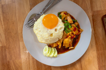 Rice topped with stir-fried chicken  and fried egg Thailand food.
