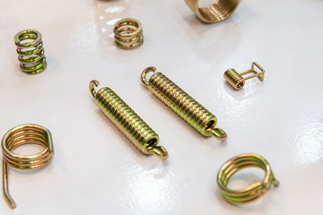 The  various type of wire spring spare parts on the white background. The industrial spare parts.