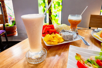 Dragon fruit shake on the table with fruit plate
