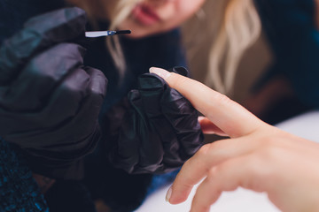 Close up of process france manicure at beauty salon.