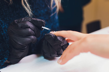 Close up of process france manicure at beauty salon.