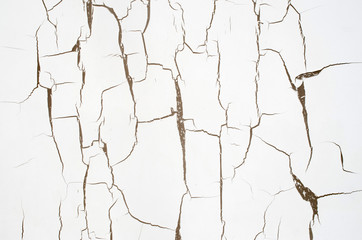 Cracked white paint on wall closeup