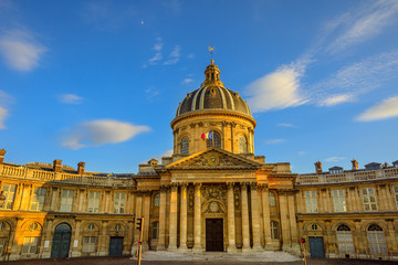 Central dome of Institut de France building, a French learned society group of five academies in Paris, France, Europe. Institut de France with Bibliotheque Nazarine in a sunny day blue sky.Copy space
