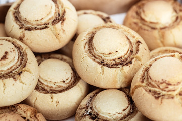Delicate crispy cookies in form of mushrooms. Baked sweet biscuits. Food background. Selective focus.