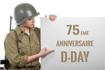 young woman dressed in us  wwii military uniform with helmet showing signboard with d-day...