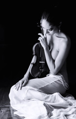 The sexy woman wearing white dress,holding violin in hand,turn face down,beauty naked body shape...