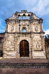 Obraz premium Church fassade ruin of Ermita de Santa Isabel with dramatic cloudscape vertical, Antigua, Guatemala