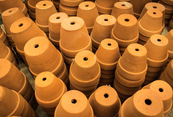 Pottery pots have the holes for drainage for planting trees in the market of Thailand