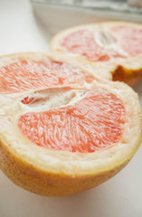 Halved juicy grapefruit. Vertical wallpaper 