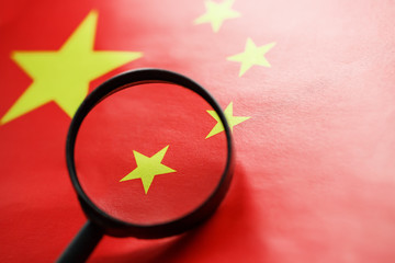 The PRC flag is looked through a magnifying glass. Spies and sightings of the People s Republic of...