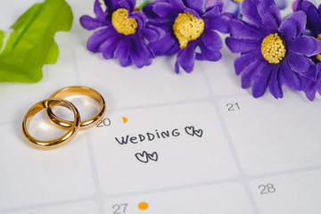 Word Wedding to Reminder Wedding day with Wedding ring on calendar planning and office tool.