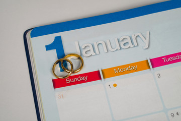 Gold Wedding ring on calendar planning or office tool.