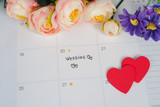 Word Wedding to Reminder Wedding day in calendar planning and pen with heart.