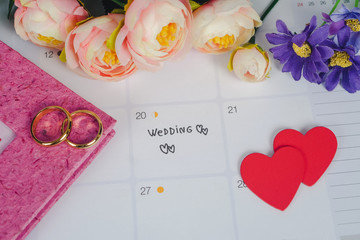 Word Wedding to Reminder Wedding day with Wedding ring on calendar planning and office tool.