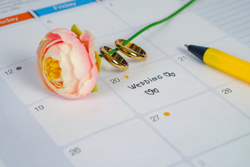 Word Wedding to Reminder Wedding day with Wedding ring on calendar planning and office tool.