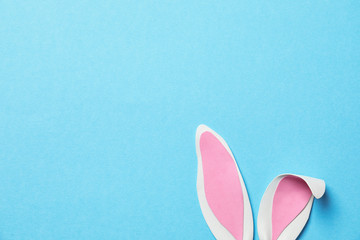 Funny Easter bunny ears on color background, top view with space for text