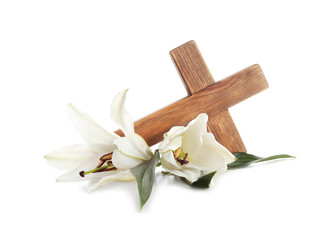 Wooden cross and blossom lilies on white background