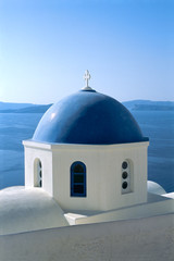 Fototapeta na wymiar Blue dome of Greek Orthodox Church in Oia, Santorini, Greece