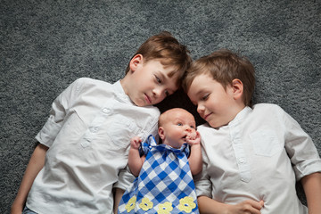 Portrait of happy brothers and cute small sister