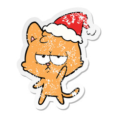 Obraz na płótnie Canvas bored distressed sticker cartoon of a cat wearing santa hat