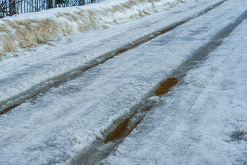 road covered with snow and ice with ruts